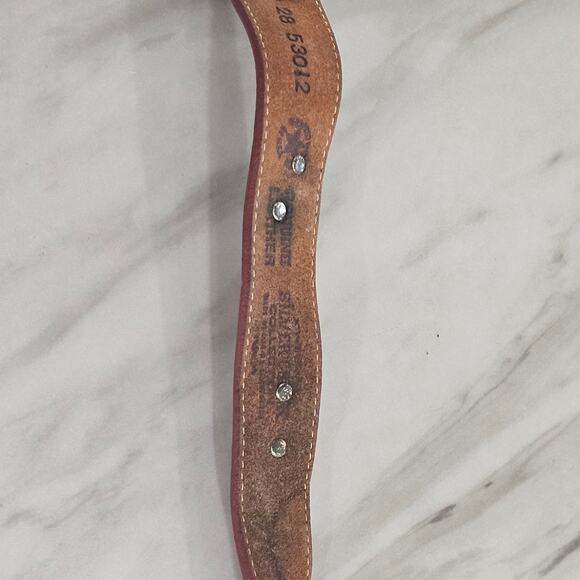 Crimson red thick leather belt with etched buckle, symbolic animal medallions